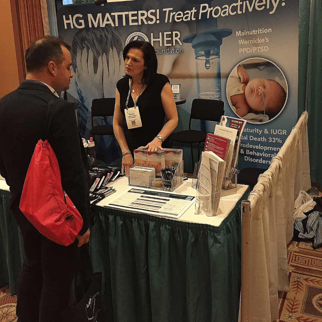 Kimber talking with a doctor at SMFM20 conference