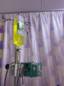 photo of IV pump and a liter fluids in a hospital setting