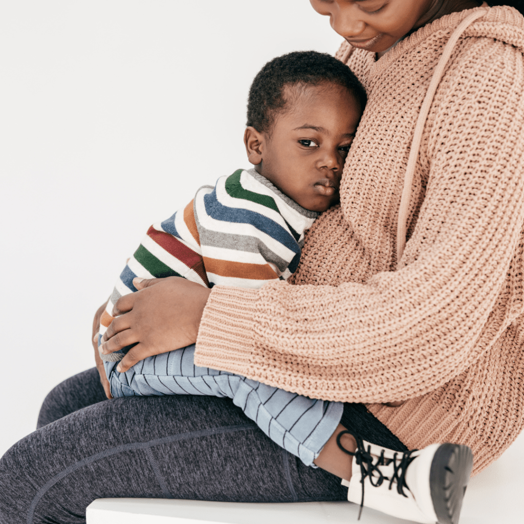 Toddler boy laying on pregnant mom. Parenting with Hg