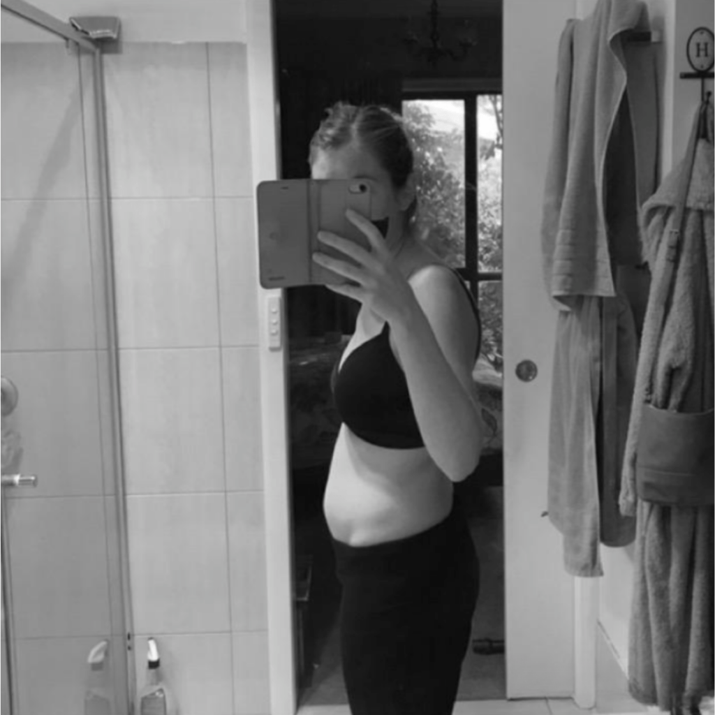 Hollie showing pregnancy bump at 11 weeks, losing 5kgs of weight. 